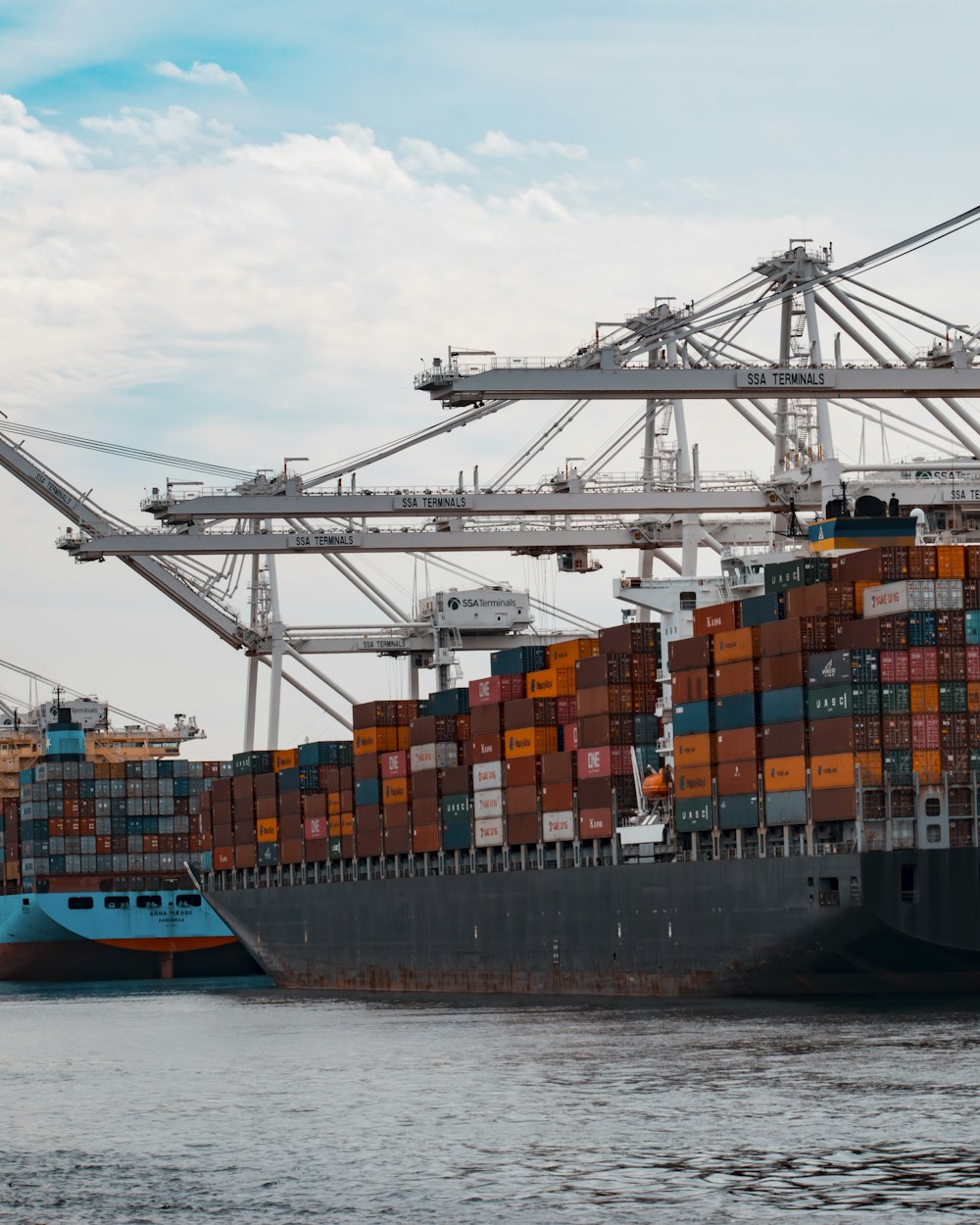 Container port with cranes and stacked shipping containers