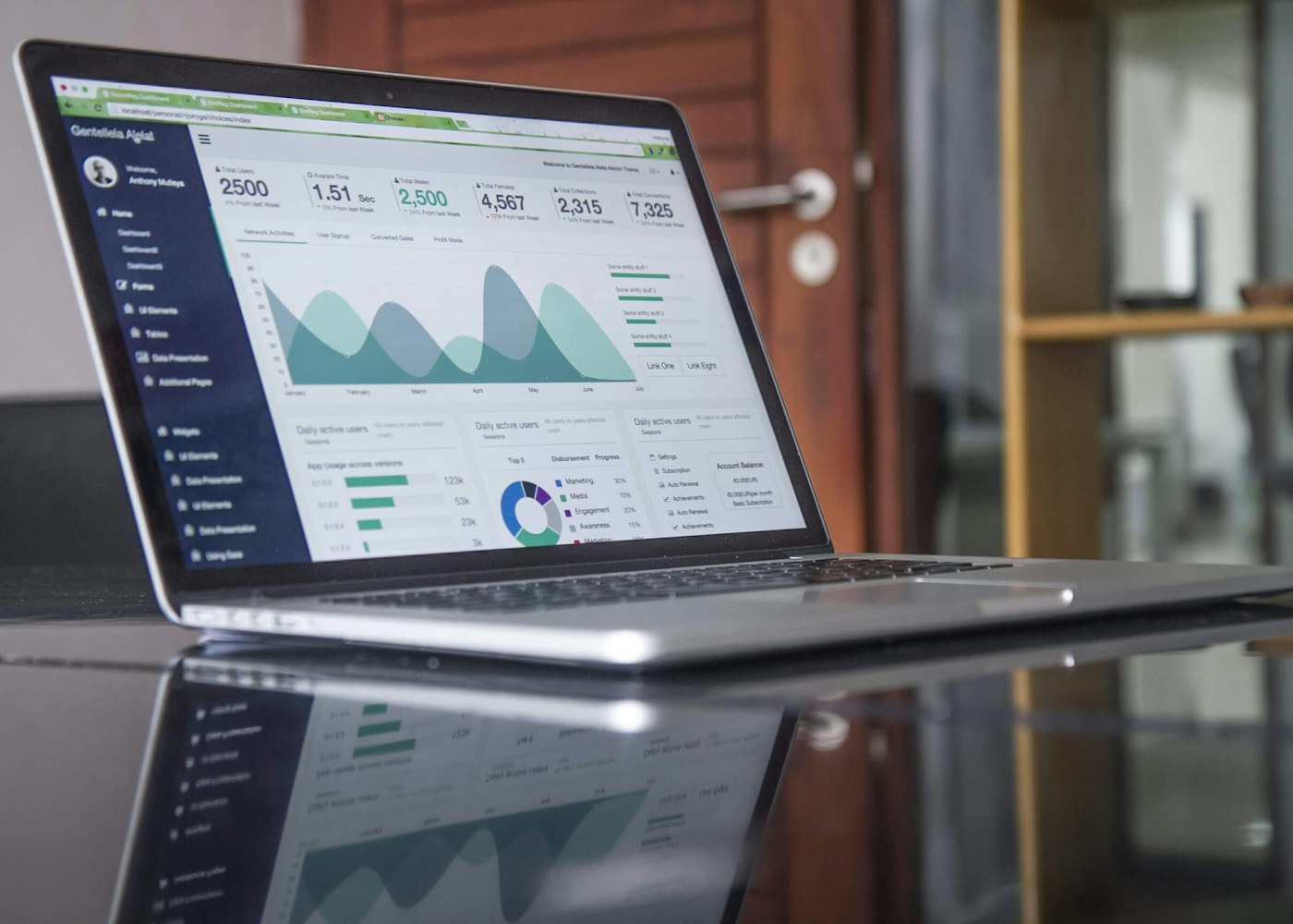 Vela Finance banking dashboard on a laptop screen
